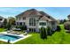 A sunny backyard features a pristine pool, elegant patio furniture, and lush, manicured greenery at 11492 Hanbury Manor Blvd, Noblesville, IN 46060