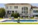 Inviting backyard with pool, lounge area, and manicured landscaping, perfect for outdoor entertaining at 11492 Hanbury Manor Blvd, Noblesville, IN 46060
