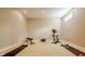 Empty basement area with hardwood floors and basic workout equipment; ready for custom design at 11492 Hanbury Manor Blvd, Noblesville, IN 46060