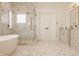Elegant bathroom features a soaking tub, glass shower, and a double vanity with modern fixtures at 11492 Hanbury Manor Blvd, Noblesville, IN 46060