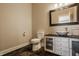 Stylish half bath with a vessel sink, black vanity, and decorative mirror at 11492 Hanbury Manor Blvd, Noblesville, IN 46060