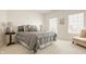 Inviting bedroom with soft color palettes, a plush bed, and an accent chair at 11492 Hanbury Manor Blvd, Noblesville, IN 46060
