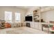 Well-lit bonus room featuring built-in shelves, white cabinets, desk space, and a plush carpet at 11492 Hanbury Manor Blvd, Noblesville, IN 46060