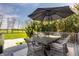 Outdoor deck featuring an umbrella-covered table with wicker chairs, ideal for al fresco dining at 11492 Hanbury Manor Blvd, Noblesville, IN 46060