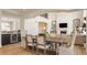 Dining area connecting to a living area features wood floors and modern decor at 11492 Hanbury Manor Blvd, Noblesville, IN 46060