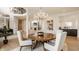 Elegant dining room with a wood table, chandelier, and access to other living areas at 11492 Hanbury Manor Blvd, Noblesville, IN 46060