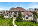 Stately stone home showcasing a manicured lawn and classic architectural design with a welcoming walkway at 11492 Hanbury Manor Blvd, Noblesville, IN 46060