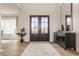 Bright foyer with hardwood floors, a decorative rug, and a dark double door entry at 11492 Hanbury Manor Blvd, Noblesville, IN 46060