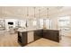 Modern kitchen featuring a large island with marble countertops and pendant lighting at 11492 Hanbury Manor Blvd, Noblesville, IN 46060