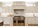 Bright kitchen featuring stainless steel range, herringbone backsplash, and white cabinetry at 11492 Hanbury Manor Blvd, Noblesville, IN 46060
