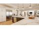 Open kitchen with stainless appliances, large island and marble countertops at 11492 Hanbury Manor Blvd, Noblesville, IN 46060