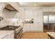 Gourmet kitchen featuring a professional-grade range, custom cabinets, and ample counter space at 11492 Hanbury Manor Blvd, Noblesville, IN 46060