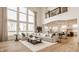 Spacious living room featuring large windows, a comfortable sectional sofa, and hardwood flooring at 11492 Hanbury Manor Blvd, Noblesville, IN 46060