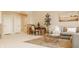 Living room with natural light, cozy seating, a desk, and a view to a door at 11492 Hanbury Manor Blvd, Noblesville, IN 46060