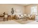 Open concept living room with large windows, comfortable seating, and an office desk at 11492 Hanbury Manor Blvd, Noblesville, IN 46060