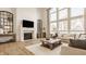 Comfortable living room featuring hardwood floors, fireplace, and plenty of natural light at 11492 Hanbury Manor Blvd, Noblesville, IN 46060