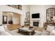 Open concept living room with hardwood floors, a fireplace, and abundant natural light at 11492 Hanbury Manor Blvd, Noblesville, IN 46060