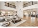 Open-concept living area boasting high ceilings, hardwood floors, and ample natural light at 11492 Hanbury Manor Blvd, Noblesville, IN 46060