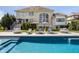 A beautiful backyard featuring a pool and elegant lounge furniture with a view of the home's exterior at 11492 Hanbury Manor Blvd, Noblesville, IN 46060