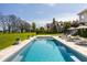 A stunning pool is the focal point of a spacious backyard with a view of the home at 11492 Hanbury Manor Blvd, Noblesville, IN 46060