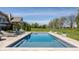 Backyard pool surrounded by lounge chairs and grassy area, perfect for summertime relaxation and recreation at 11492 Hanbury Manor Blvd, Noblesville, IN 46060