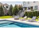 Relaxing poolside view featuring lounge chairs and a cozy outdoor seating area surrounded by lush greenery at 11492 Hanbury Manor Blvd, Noblesville, IN 46060