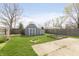 Spacious backyard featuring a charming shed, garden beds, concrete patio, and a well-maintained lawn at 2819 Mars Hill St, Indianapolis, IN 46241