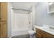 Bathroom with a white tub, shower, and vanity with wood cabinets and tiled floor at 2819 Mars Hill St, Indianapolis, IN 46241