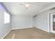 This bedroom has carpeted floors, gray walls, a ceiling fan, and a glass door at 2819 Mars Hill St, Indianapolis, IN 46241