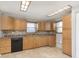Kitchen features tile backsplash, wood cabinets, and laminate countertops at 2819 Mars Hill St, Indianapolis, IN 46241