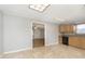 Bright kitchen features tile floor, wood cabinets, a window, and a view into the living room at 2819 Mars Hill St, Indianapolis, IN 46241