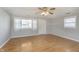 Bright living room with wood floors, neutral walls, ceiling fan, and natural light from large windows at 2819 Mars Hill St, Indianapolis, IN 46241