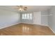 Cozy living room featuring neutral walls, ceiling fan, wood-look flooring, and natural lighting at 2819 Mars Hill St, Indianapolis, IN 46241