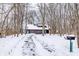 Long driveway to a brown house with two-car garage, and a mailbox in the snow at 10555 E 400 S, Zionsville, IN 46077