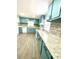 Renovated kitchen with teal cabinets and granite countertops at 2709 E Troy Ave, Indianapolis, IN 46203