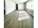 Sunlit living room featuring hardwood floors and access to patio at 2709 E Troy Ave, Indianapolis, IN 46203