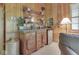 Charming bar area with wooden cabinetry, countertop space, mini fridge, and decorative mirror at 6486 Coyote Dr, Nineveh, IN 46164