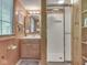 Cozy bathroom with light wood paneling, single sink vanity, and step in shower at 6486 Coyote Dr, Nineveh, IN 46164