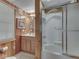 Compact bathroom featuring a shower and tub with a vanity and wood paneling at 6486 Coyote Dr, Nineveh, IN 46164