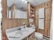 This charming bathroom features wood paneling and a mirrored medicine cabinet for a rustic yet functional feel at 6486 Coyote Dr, Nineveh, IN 46164