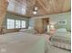 Bright bedroom featuring wood ceilings and trim, three beds, bedside tables, and a window for ample natural light at 6486 Coyote Dr, Nineveh, IN 46164