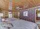 Cozy bedroom with two beds, floral wallpaper, and rustic wood ceiling at 6486 Coyote Dr, Nineveh, IN 46164