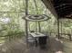 Scenic deck view featuring an outdoor dining set and umbrella, nestled in lush greenery for relaxing or entertaining at 6486 Coyote Dr, Nineveh, IN 46164