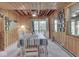 Inviting dining room with wood paneling, large windows, and a stylish table setting at 6486 Coyote Dr, Nineveh, IN 46164
