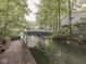 Dock on the lake features canopy and lake views surrounded by lush greenery at 6486 Coyote Dr, Nineveh, IN 46164