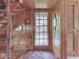 Cozy entryway with natural wood walls, unique staircase and terra cotta tile flooring at 6486 Coyote Dr, Nineveh, IN 46164