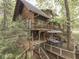 Stunning log cabin featuring a spacious deck for outdoor dining and relaxation in a tranquil setting at 6486 Coyote Dr, Nineveh, IN 46164