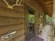 Charming wood cabin exterior with covered porch, decorative touches, and rustic design elements at 6486 Coyote Dr, Nineveh, IN 46164