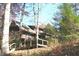 Rustic wooden house with a porch nestled among colorful autumn trees at 6486 Coyote Dr, Nineveh, IN 46164