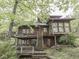 A lovely view of the wooden home and outdoor dining area surrounded by foliage with lots of natural light at 6486 Coyote Dr, Nineveh, IN 46164